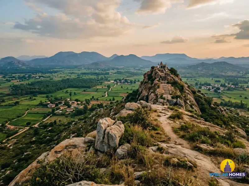 Rocky hilltop viewpoint at Avalabetta overlooking layered green hills at sunrise