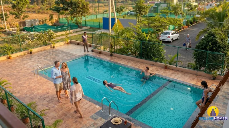 Aerial view of residents around the Stellar Mulberry clubhouse swimming pool, with sports courts, palm trees and guest parking visible in the background